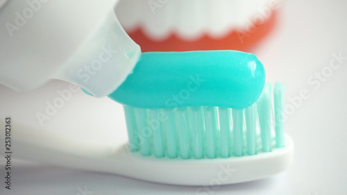 Toothbrush and toothpaste on blurred background, closeup