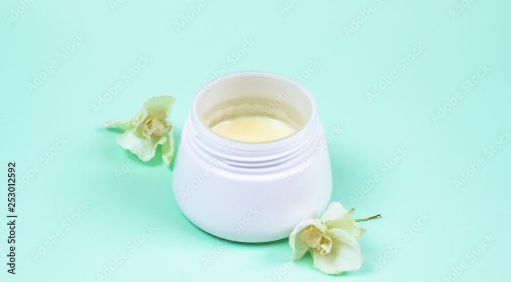 Natural cosmetic products on a blue background..A jar of natural cosmetic cream Natural cosmetic products on a blue background..A jar of natural cosmetic cream