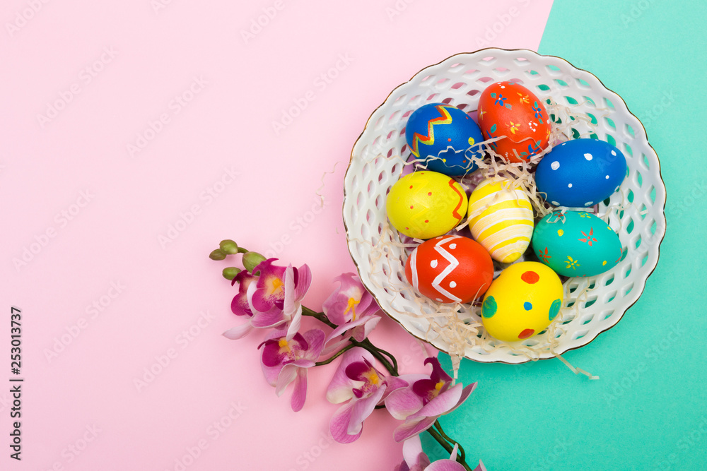 easter eggs on plate on colour background