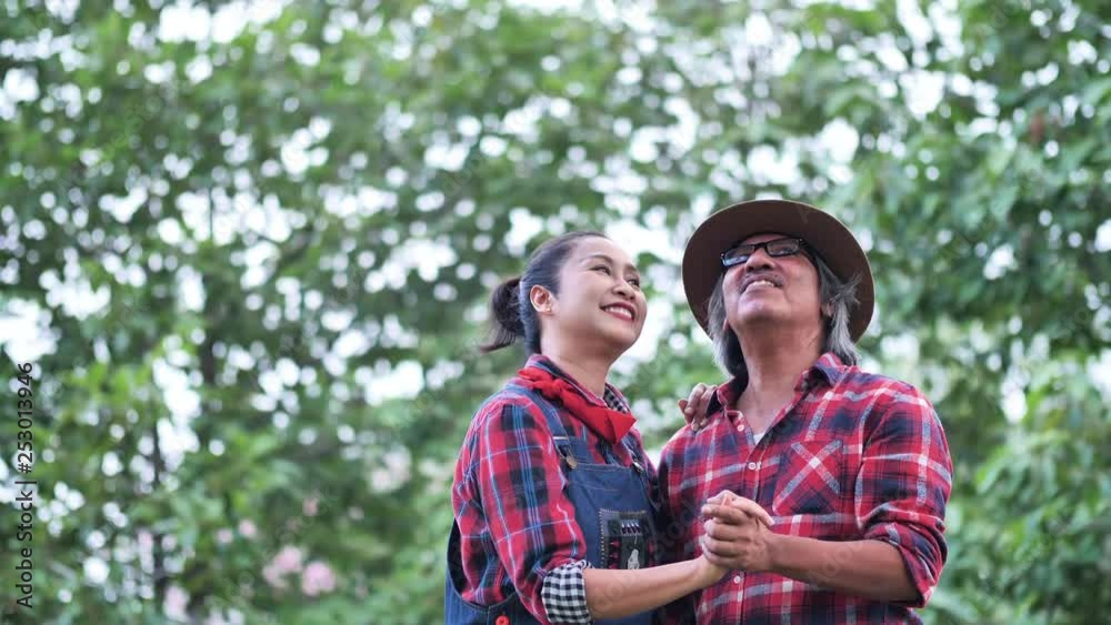 Asian senior couple dancing together in garden at home. family, Happy, Health, environment, Hobbies after retirement. Slow Motion Asian senior couple dancing together in garden at home. family, Happy, Health, environment, Hobbies after retirement. Slow Motion
