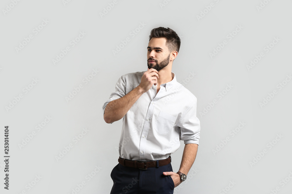 Fashionable young man on light background Fashionable young man on light background