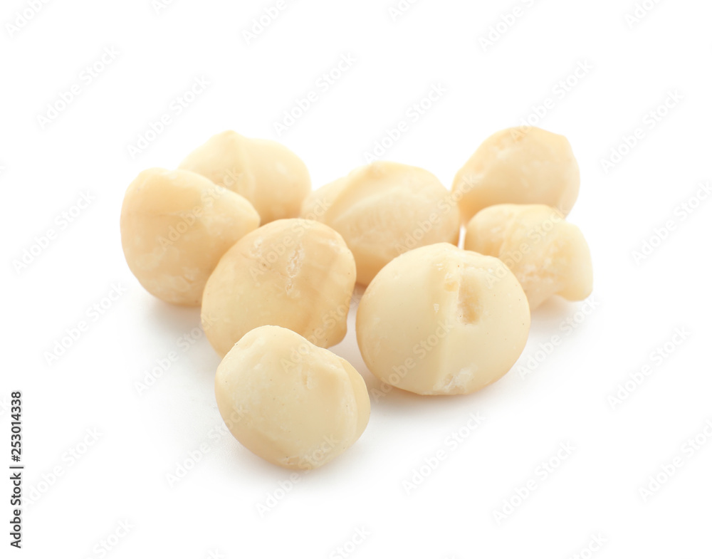 Peeled macadamia nuts on white background