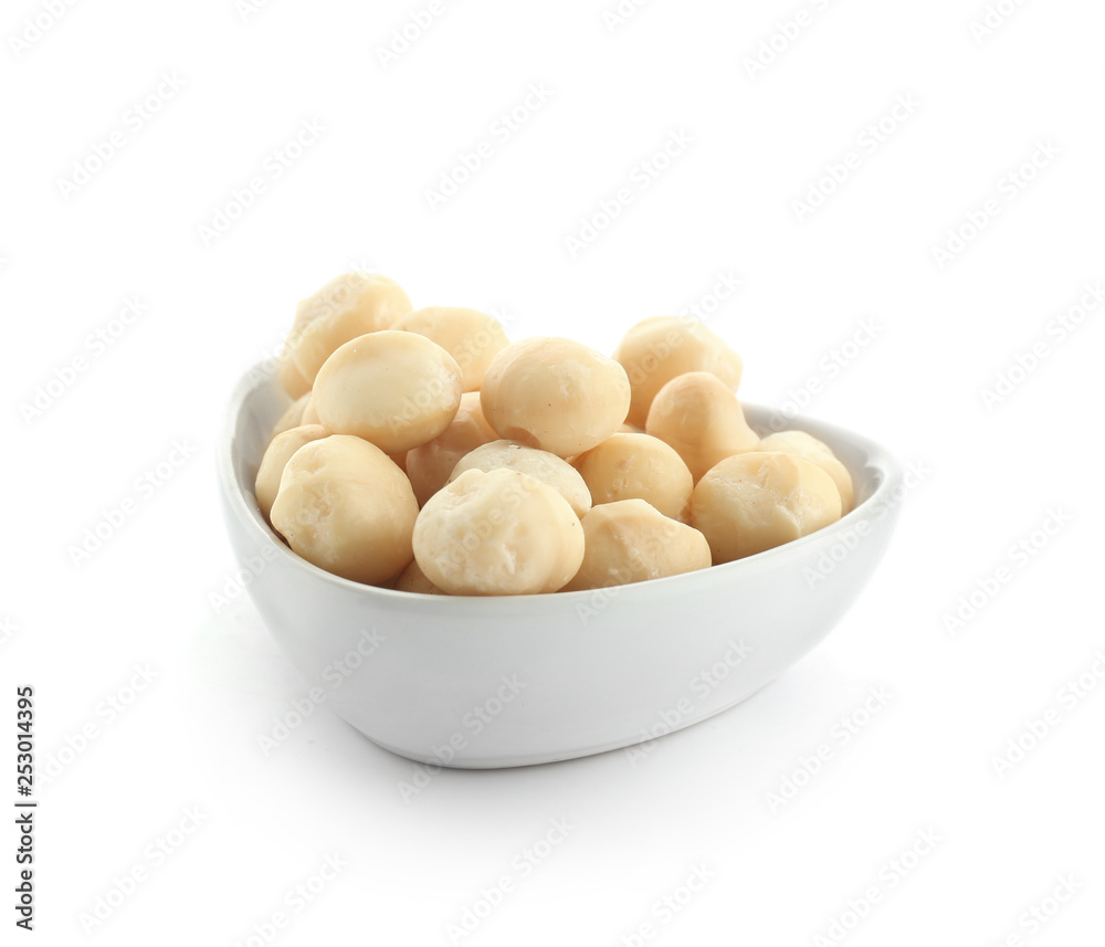 Bowl with peeled macadamia nuts on white background Bowl with peeled macadamia nuts on white background