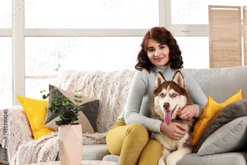 Young woman with her cute dog at home © Pixel-Shot