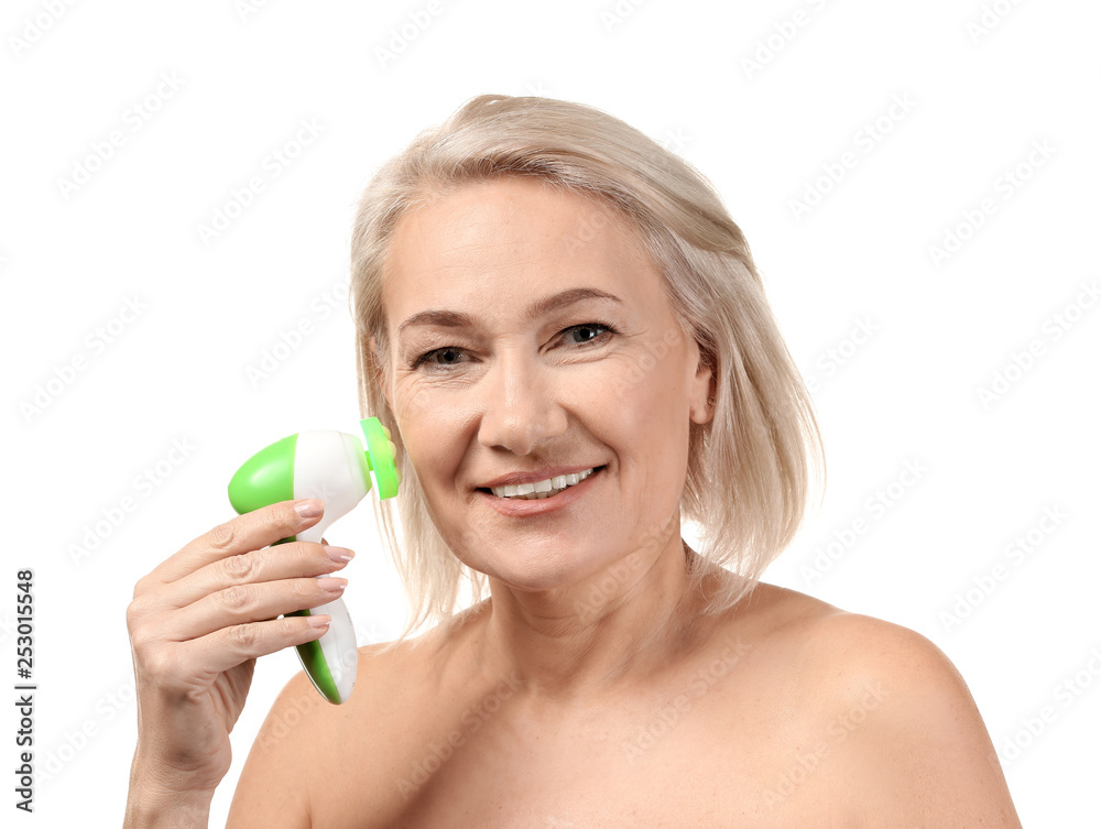 Mature woman with facial massage tool on white background Mature woman with facial massage tool on white background