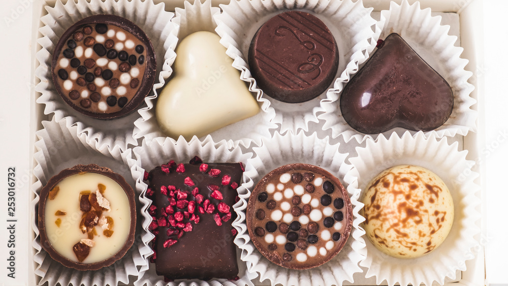 Assorted chocolates in a box. Candies in a box. Top view. Closeup Assorted chocolates in a box. Candies in a box. Top view. Closeup