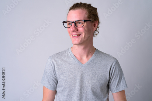 Face of happy young handsome man with eyeglasses thinking © Ranta Images