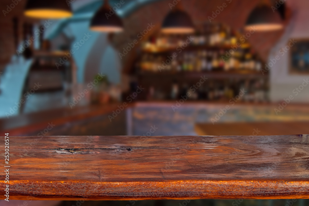 Mockup. Blurred bar in the background. A wooden board in the foreground. Mockup. Blurred bar in the background. A wooden board in the foreground.