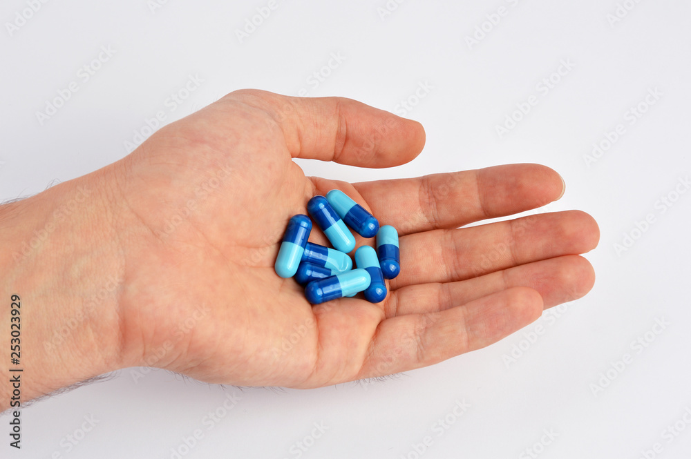 Hand holding capsules