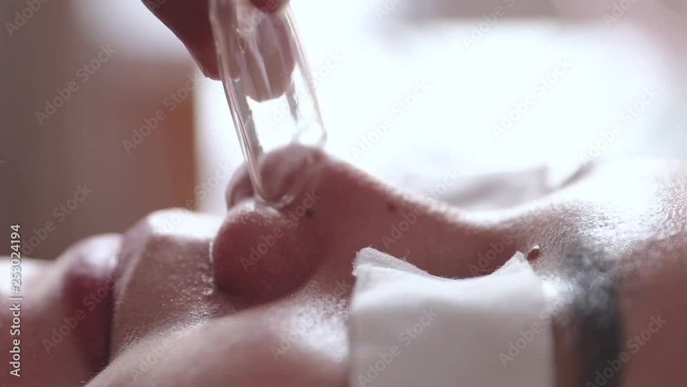 beautiful young asian woman getting blackhead suction treatment at spa salon