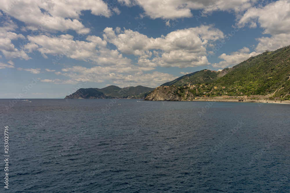 Italy, Cinque Terre, Manarola, a body of water with a mountain in the background