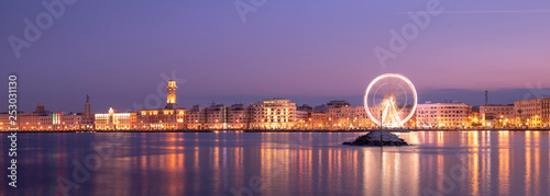 Night view of Illuminated giant Ferris wheel on the waterfront of Bari, region of Apulia, Italy. Puglia 
