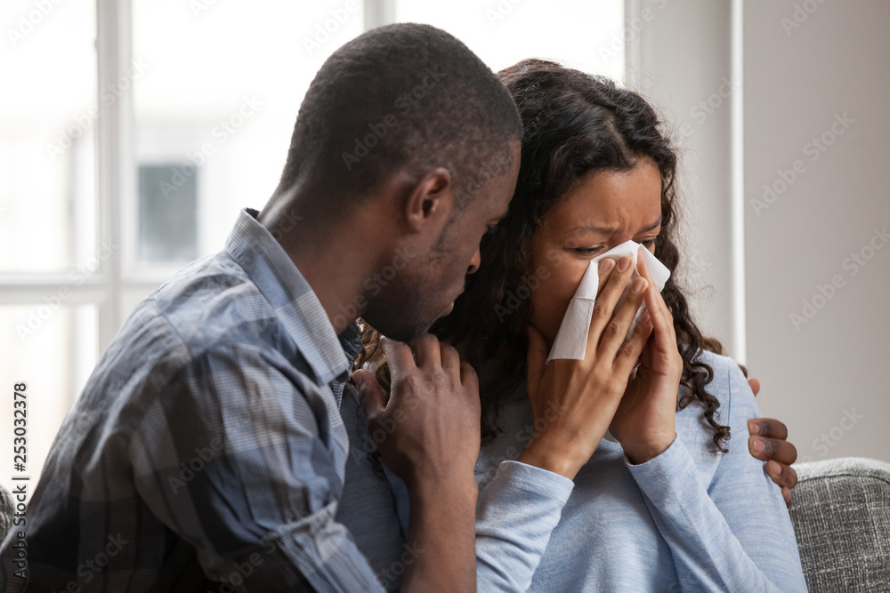 Caring black husband hug supporting sad crying wife Stock Photo Adobe