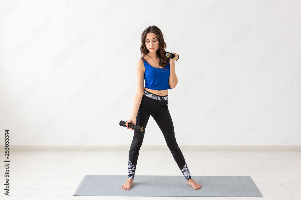 Healthy lifestyle, people and sport concept - Athletic woman doing exercise for arms