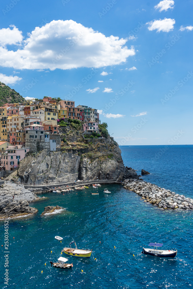 Italy, Cinque Terre, Manarola, Cinque Terre, an island in the middle of a body of water with Cinque Terre in the background