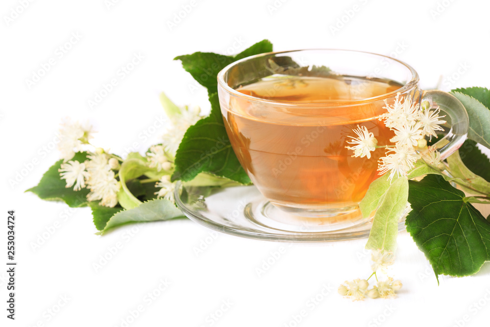 Linden tea on a white table in a glass cup. Flower tea, herbal medicine. Linden tea on a white table in a glass cup. Flower tea, herbal medicine.