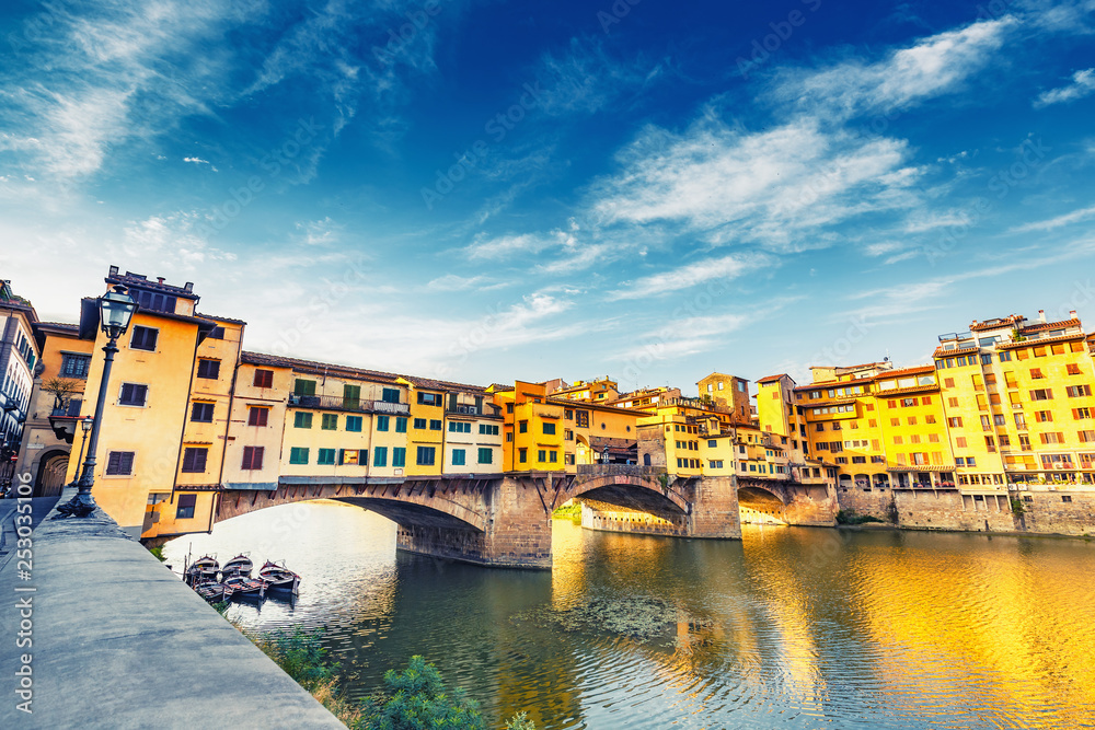 Scenic view on Ponte Vecchio in Florence, Italy, on a summer day. Colorful travel background.