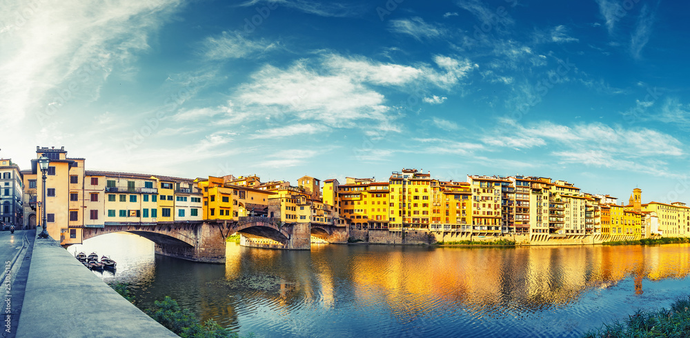 Scenic view on Ponte Vecchio in Florence, Italy, on a summer day. Colorful travel background. Panorama view. - obrazy, fototapety, plakaty 