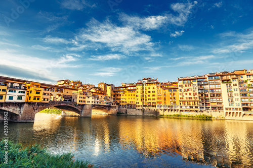Scenic view on Ponte Vecchio in Florence, Italy, on a summer day. Colorful travel background.