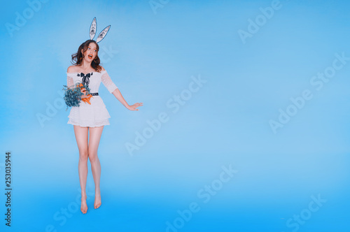 amazing cute redhead model in a short white dress, sexy hot girl in the image of the Easter bunny, playboy bunny with an orange carrot in her hands, Korean fashion for European women, space for text