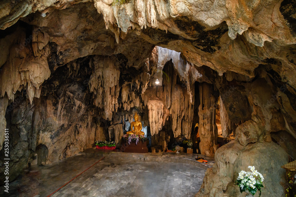 Stalactite limestone cave with buddha statue