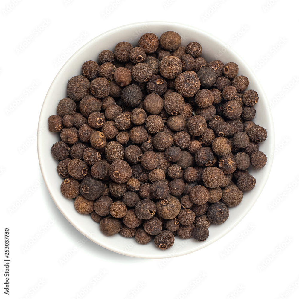 Allspice spice in bowl isolated on white background. Top view Allspice spice in bowl isolated on white background. Top view