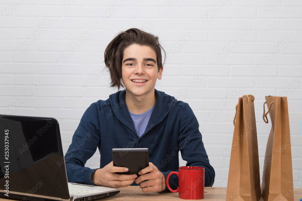 young man with calculator and laptop buying online young man with calculator and laptop buying online