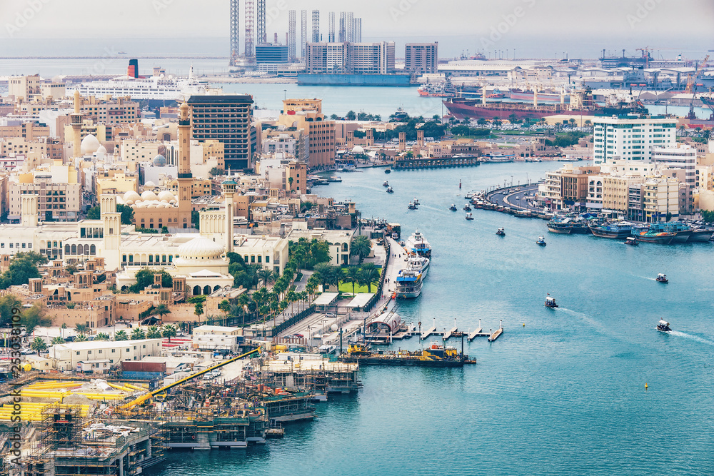 Aerial daytime skyline of Dubai, UAE. View on harbor in the distance. Scenic travel background.