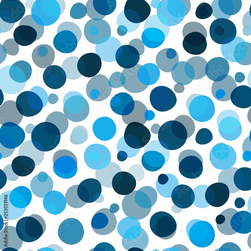 Seamless pattern with blue large and small deformed polka dots