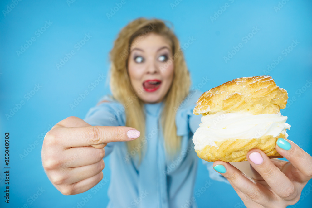 Woman holding sweet delicious cream cupcake