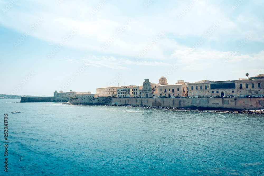 Old buildings in seafront of Ortygia (Ortigia) Island, Syracuse, traditional architecture of Sicily, Italy.