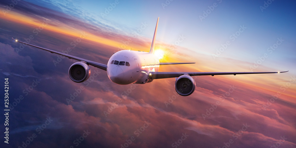 Commercial airplane jetliner flying above dramatic clouds in beautiful sunset light. Travel concept. - obrazy, fototapety, plakaty 