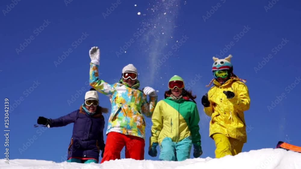 Four women at mountain top. Take a selfie. Holiday, fun. Color alpine skiing suits. Slow-motion shot. Four women at mountain top. Take a selfie. Holiday, fun. Color alpine skiing suits. Slow-motion shot.