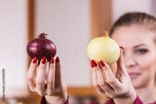 Woman holding red and white onion