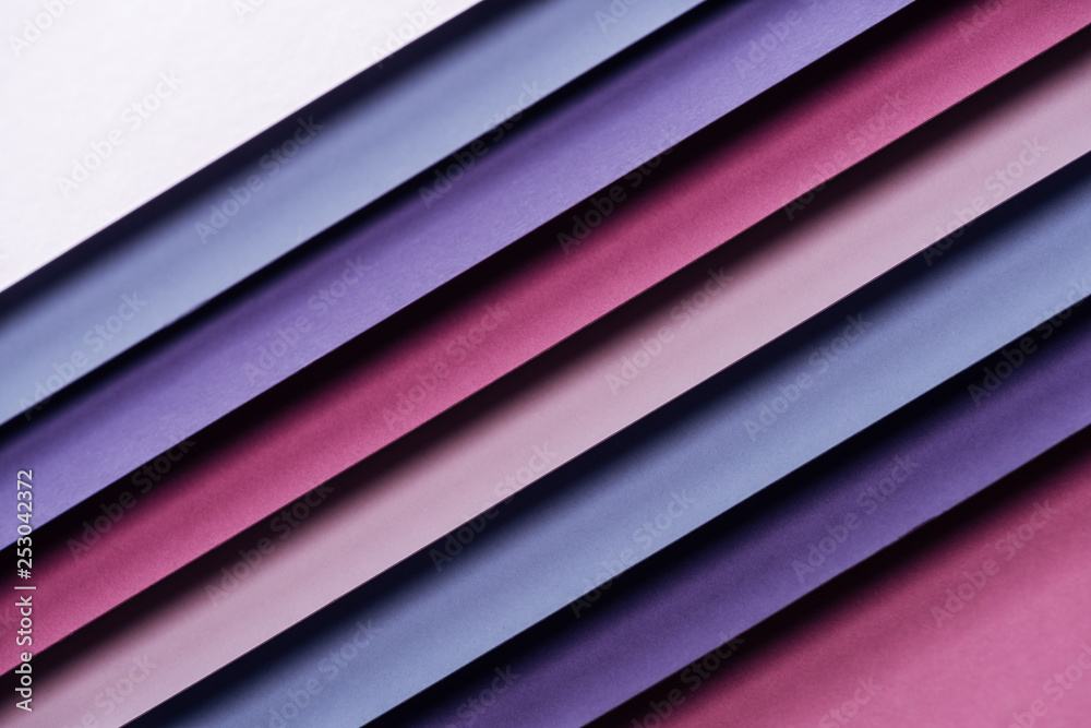 bright blue, white, pink, burgundy and purple sheets of paper on pink background bright blue, white, pink, burgundy and purple sheets of paper on pink background