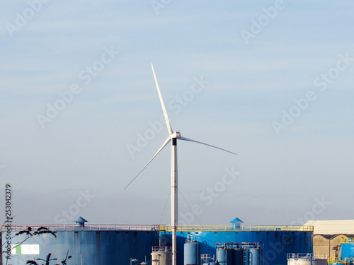 a wind turbine over blue sky