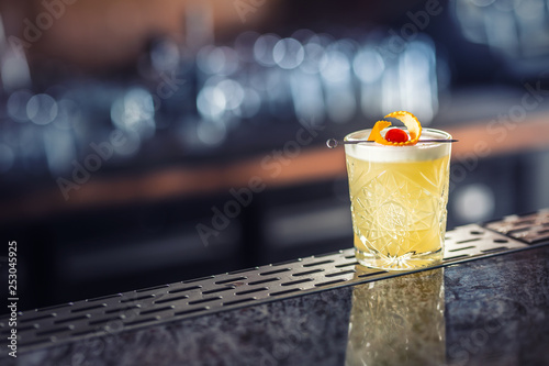 Cocktail drink whiskey sour at barcounter in night club or restaurant