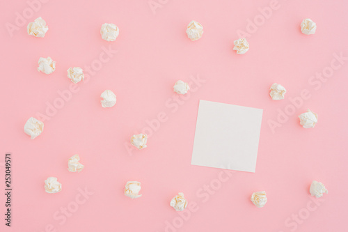 Paper note and crumpled pieces of paper on pink table. Flat lay. © mallmo