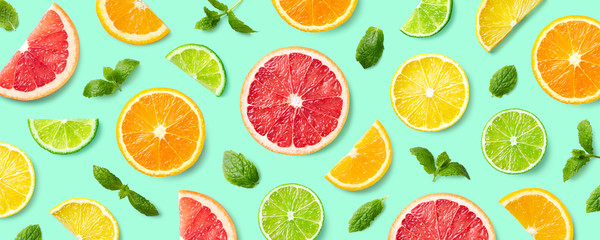 Colorful pattern of citrus fruit slices and mint leaves