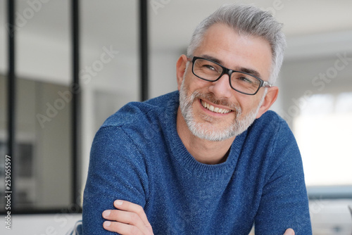 Portrait of smiling man with grey hair and glasses photo