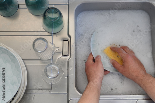 Obraz na płótnie Top view of man's hands washing up in kitchen