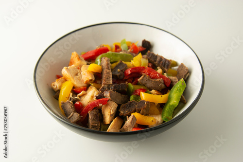 Fry meat with vegetables on white background. Dinner. Delicious lunch. Assian, chinese food. Healthy food.