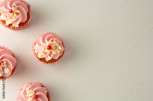 Pink, strawbery, fruit cupcakes isoalted. Sweet dessert, shortcakes with cream. Birthday food, cake, muffin. flat lay, copy space for text. Tempalte for food blog or food social media content.