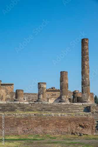 POMPEII, ITALY - 8 August 2015: Ruins of antique roman temple in Pompeii near volcano Vesuvius, Naples, Italy.