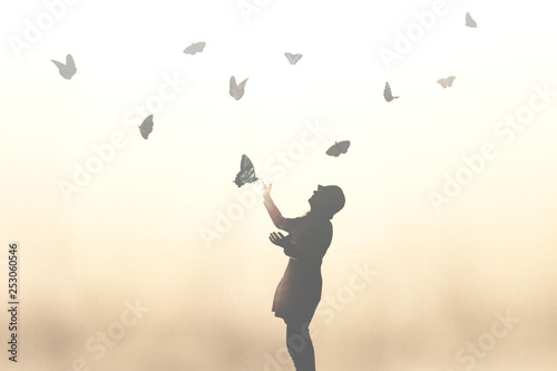surreal moment of a woman dancing with butterflies 