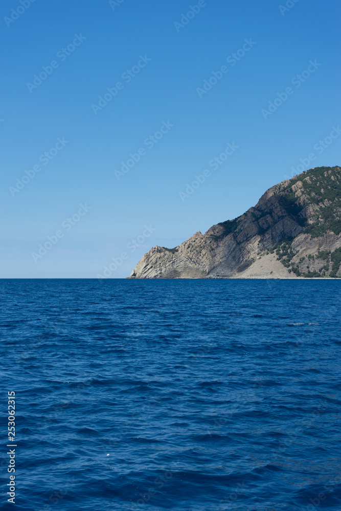 Italy, Cinque Terre, Monterosso, a large body of water with a mountain in the ocean