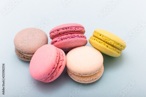 Cake macaron or macaroon on turquoise background from above, almond cookies, pastel colors