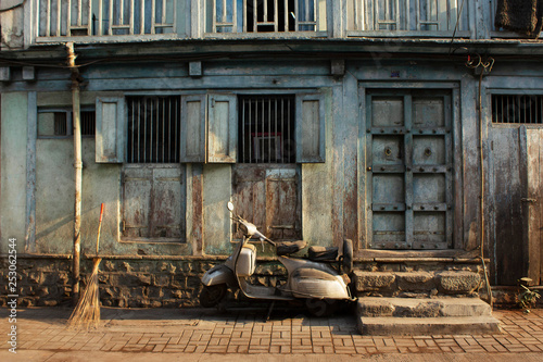 Old home and scooter parked outside, Pune street, Maharashtra, India