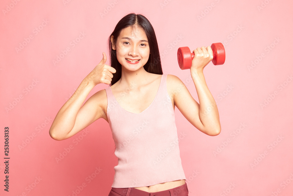 Healthy Asian woman thumbs up with dumbbells. Healthy Asian woman thumbs up with dumbbells.