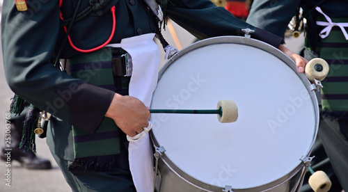 Close-up of Bagpiper playing drum